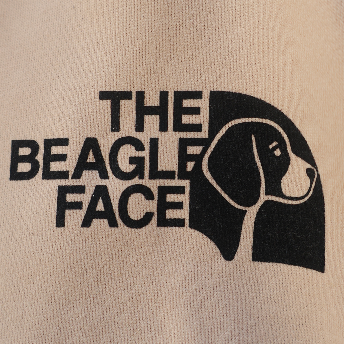 Beige fabric with black text 'THE BEAGLE FACE' and a beagle outline.