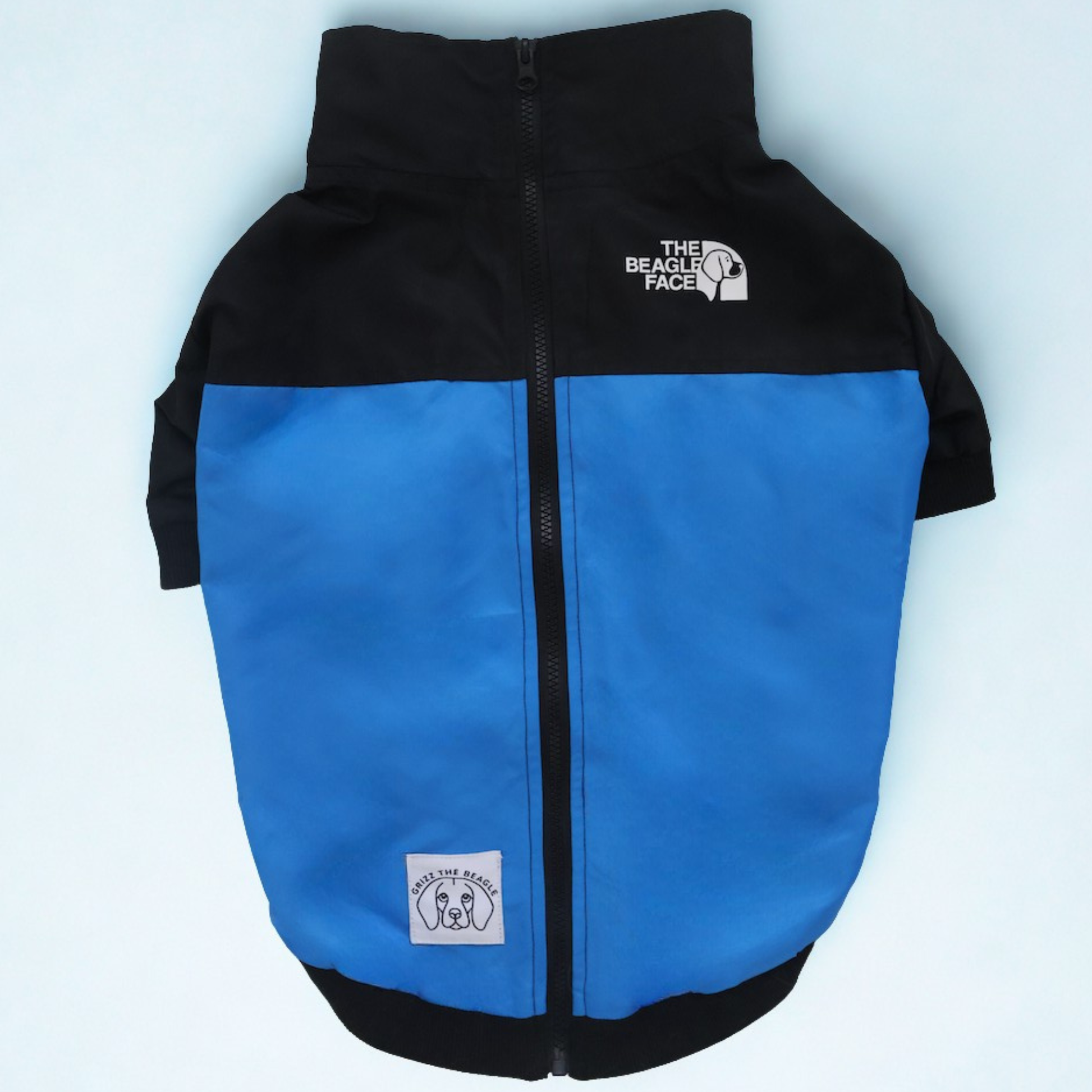 Blue and black dog jacket with a brand logo on a light blue background