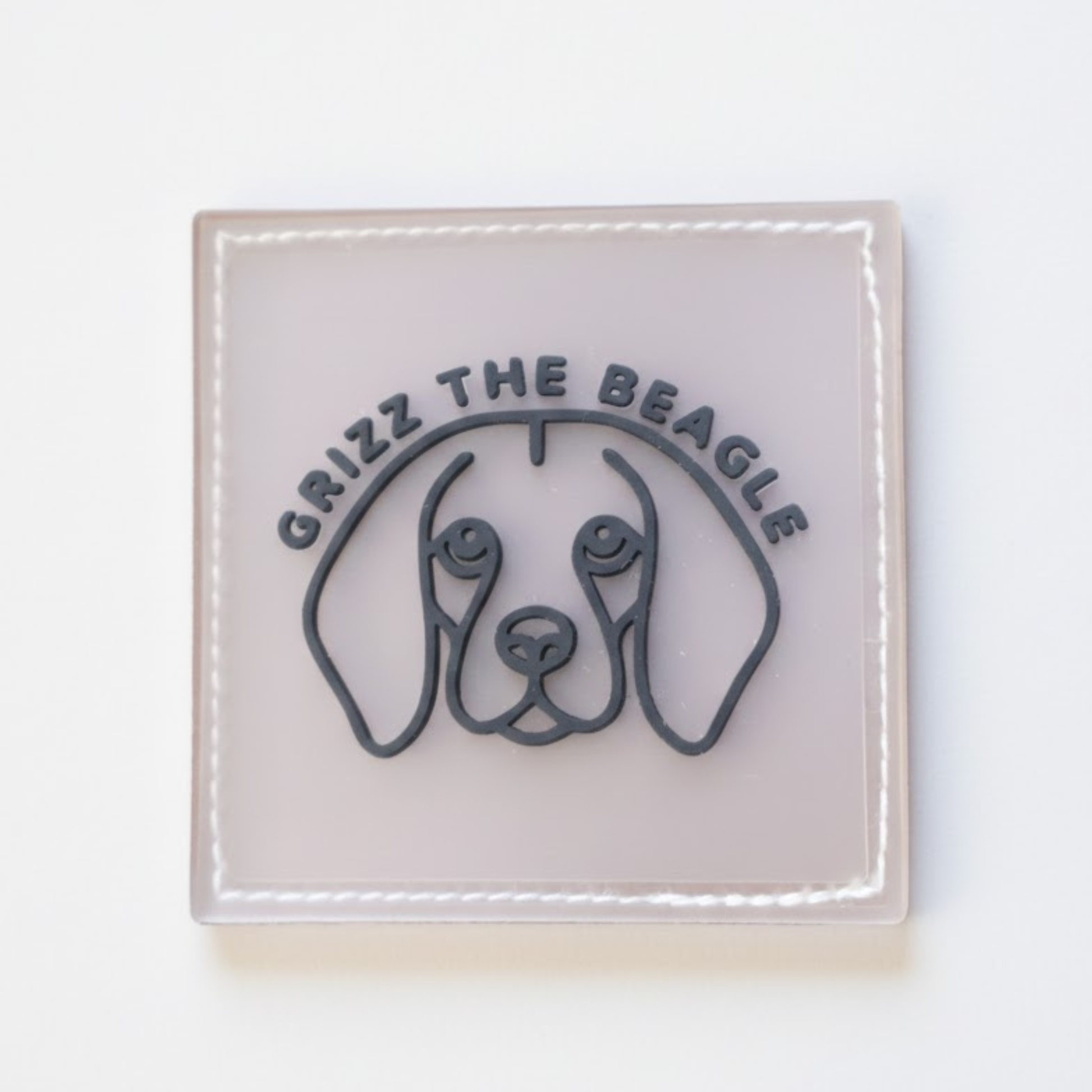 Square logo callout with 'Grizz the Beagle' text on a white background
