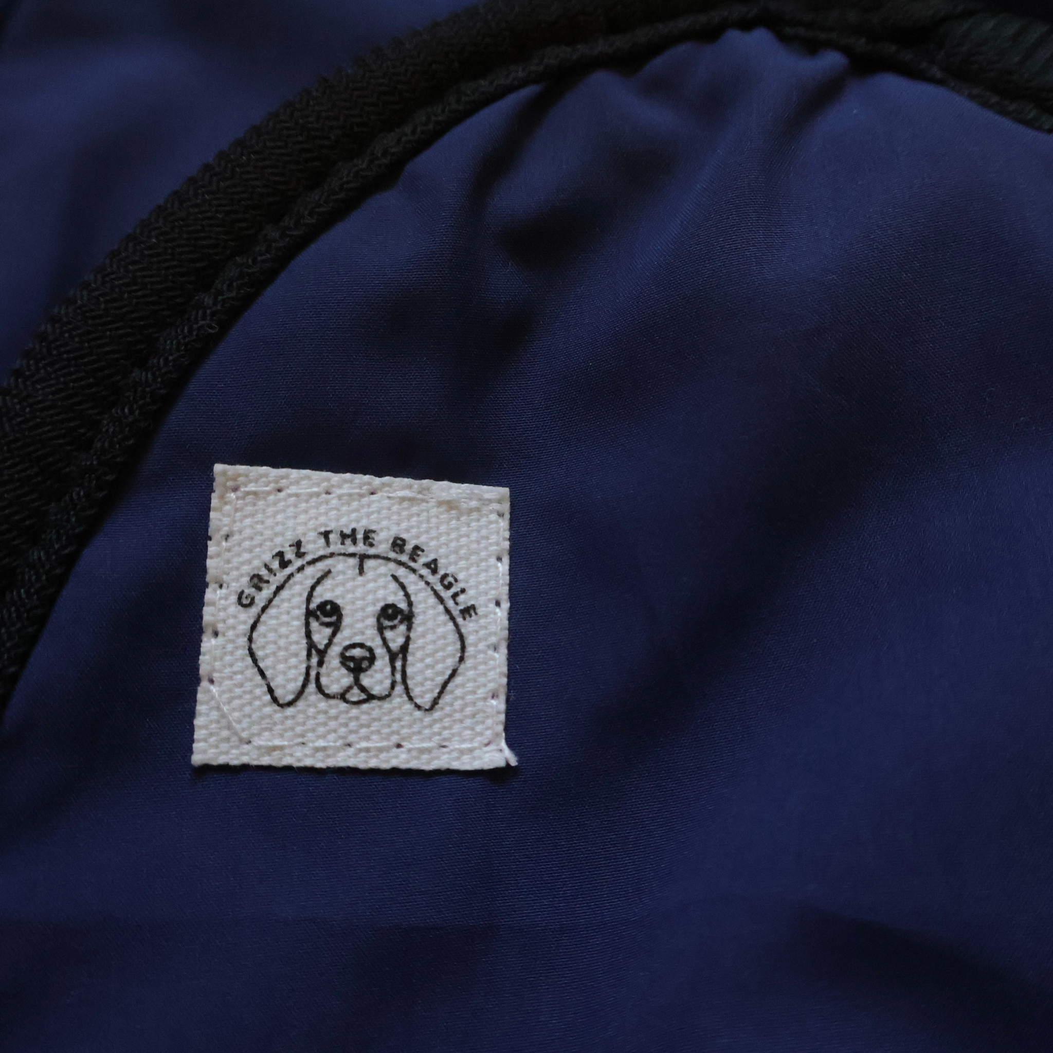 Close-up of Midnight Howl ear muffs featuring a dog illustration and text.
